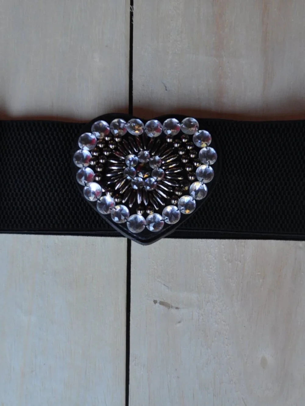 women's black elastic waistband belt features a distinct faux leather heart-shap